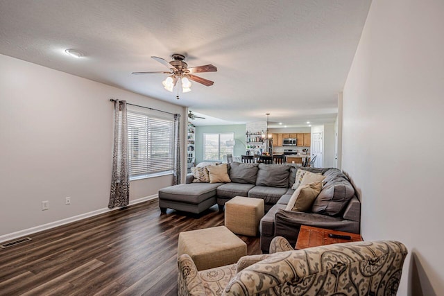 9128 Belvedere Ct, Florence, KY 41042 - living room featuring dark wood-style floors, ceiling fan, and a chandelier