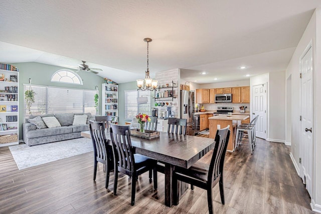 9128 Belvedere Ct, Florence, KY 41042 - dining room with a ceiling fan, dark wood-type flooring, vaulted ceiling, and a chandelier