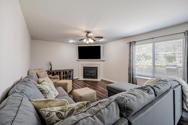 9128 Belvedere Ct, Florence, KY 41042 - living room with dark wood-type flooring, a ceiling fan, and a tiled fireplace