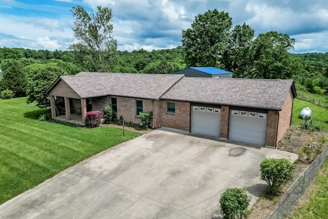 1041 Kidwell Rd, Demossville, KY 41033 - ranch-style home with an attached garage, concrete driveway, brick siding, a front lawn, and a view of trees