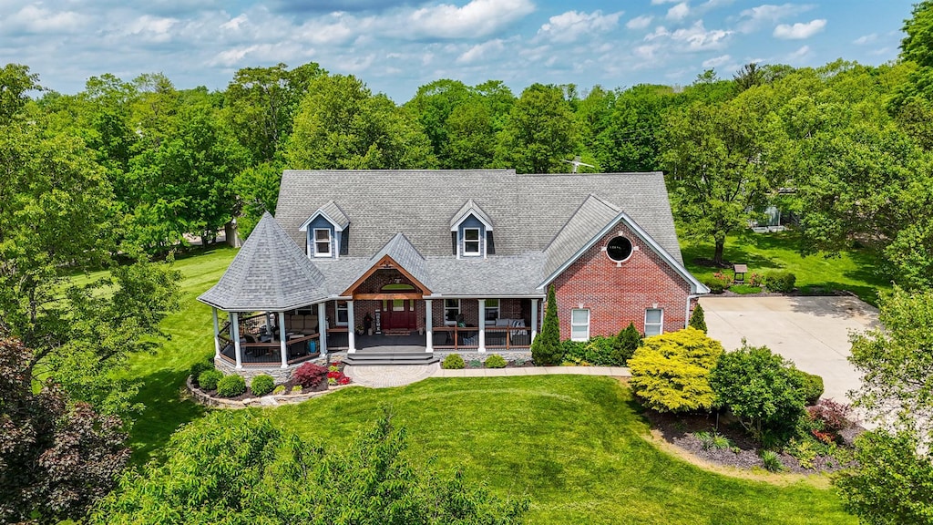 9015 Washington Trace Rd, California, KY 41007 - cape cod home featuring covered porch, a front lawn, and brick siding