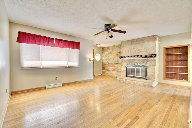 5370 Skyline Dr, Highland Heights, KY 41076 - unfurnished living room featuring ceiling fan, a textured ceiling, hardwood / wood-style flooring, and a fireplace