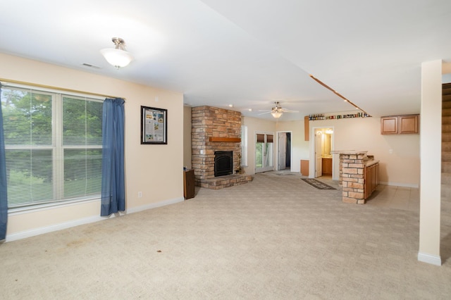 1464 Shirepeak Way, Independence, KY 41051 - unfurnished living room with a stone fireplace, light colored carpet, ceiling fan, and plenty of natural light