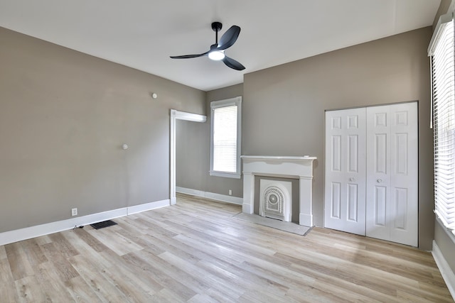 1508 Holman Ave, Covington, KY 41011 - unfurnished living room featuring ceiling fan, wood finished floors, and a fireplace