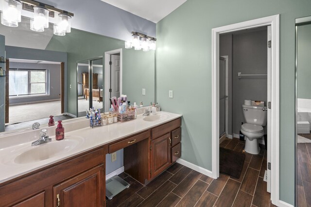 25 Regiment Ct, Wilder, KY 41076 - full bathroom featuring double vanity, wood finish floors, and vaulted ceiling