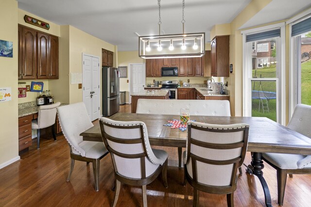 25 Regiment Ct, Wilder, KY 41076 - dining space featuring dark wood finished floors and built in desk