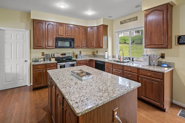 25 Regiment Ct, Wilder, KY 41076 - kitchen with black appliances, light stone counters, and wood finished floors