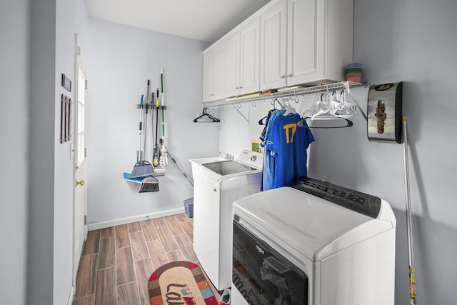 25 Regiment Ct, Wilder, KY 41076 - laundry area with washer and dryer, cabinet space, and wood tiled floors