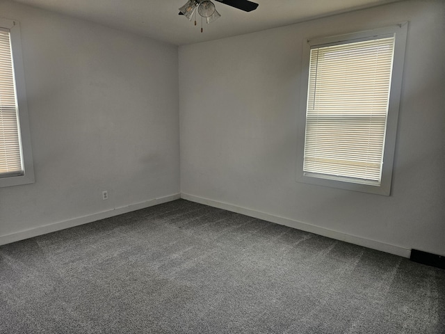330 Silver St, Dayton, KY 41074 - empty room featuring dark carpet, ceiling fan, and healthy amount of natural light
