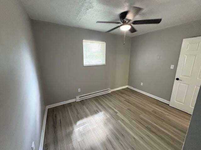 1022 Capitol Ave, Elsmere, KY 41018 - empty room with a baseboard radiator, ceiling fan, wood finished floors, and a textured ceiling