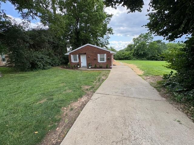 1022 Capitol Ave, Elsmere, KY 41018 - view of property exterior with a lawn, concrete driveway, and brick siding
