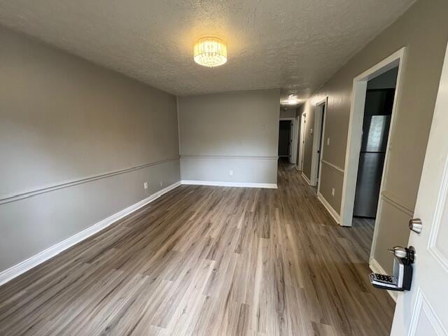 1022 Capitol Ave, Elsmere, KY 41018 - unfurnished room with a textured ceiling and wood finished floors