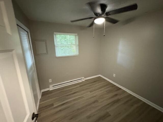 1022 Capitol Ave, Elsmere, KY 41018 - unfurnished bedroom with a baseboard heating unit, dark wood finished floors, and a ceiling fan