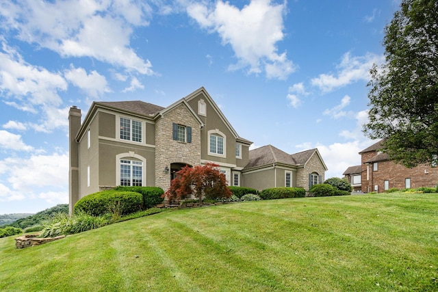 2316 Pinnacle Ct, Hebron, KY 41048 - traditional-style house with stucco siding, a chimney, stone siding, and a front yard