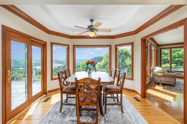 2316 Pinnacle Ct, Hebron, KY 41048 - dining area with light wood-style floors, a ceiling fan, a tray ceiling, and crown molding