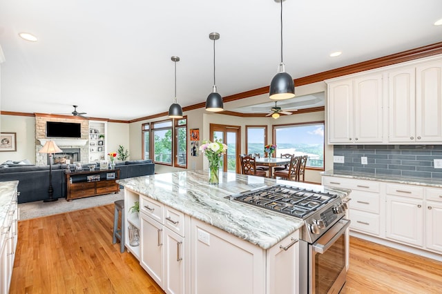 2316 Pinnacle Ct, Hebron, KY 41048 - kitchen with a ceiling fan, stainless steel range with gas stovetop, light wood-type flooring, a kitchen island, and recessed lighting