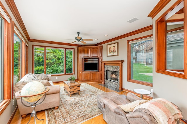 2316 Pinnacle Ct, Hebron, KY 41048 - living area with light wood finished floors, ornamental molding, a ceiling fan, and a premium fireplace