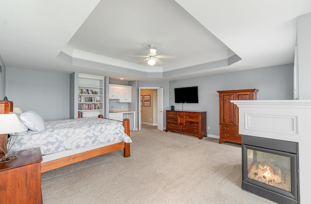 2316 Pinnacle Ct, Hebron, KY 41048 - bedroom featuring a tray ceiling, ornamental molding, light carpet, a multi sided fireplace, and ceiling fan