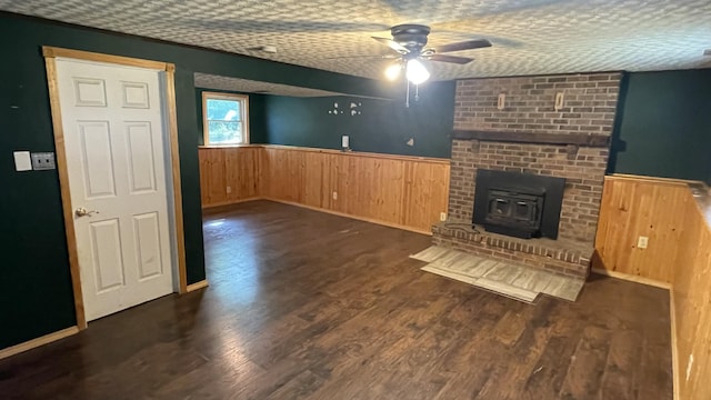 38 Carriage Hill Dr, Erlanger, KY 41018 - unfurnished living room featuring wainscoting, ceiling fan, wood walls, wood finished floors, and a wood stove
