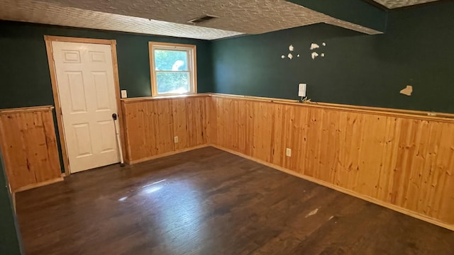 38 Carriage Hill Dr, Erlanger, KY 41018 - empty room featuring wainscoting, wood walls, a textured ceiling, and wood finished floors