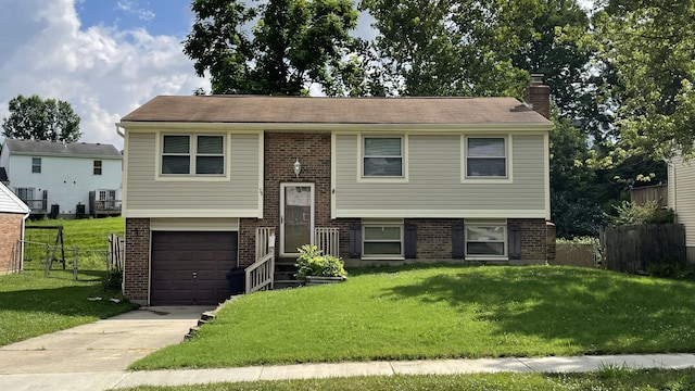 38 Carriage Hill Dr, Erlanger, KY 41018 - raised ranch with brick siding, a chimney, an attached garage, and driveway