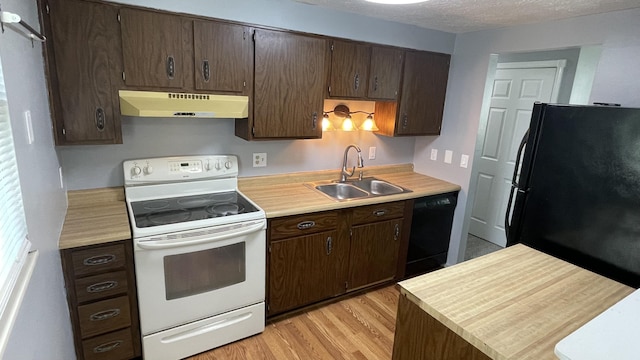 38 Carriage Hill Dr, Erlanger, KY 41018 - kitchen with black appliances, under cabinet range hood, light countertops, dark brown cabinetry, and a textured ceiling