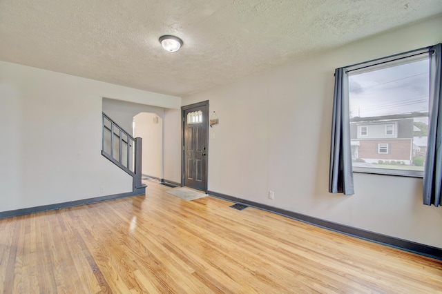2 Doris Dr, Latonia, KY 41015 - spare room with arched walkways, wood finished floors, a textured ceiling, and stairs