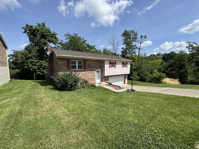 4120 Taylor Ct, Erlanger, KY 41018 - raised ranch with concrete driveway, a garage, brick siding, a chimney, and a front yard