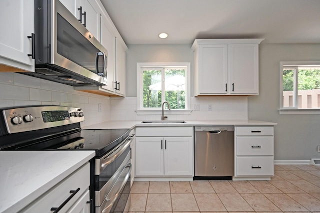 42 Daisy Ln, Fort Thomas, KY 41075 - kitchen featuring stainless steel appliances, healthy amount of natural light, backsplash, white cabinetry, and recessed lighting