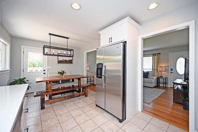 42 Daisy Ln, Fort Thomas, KY 41075 - kitchen with stainless steel fridge, plenty of natural light, white cabinetry, light tile patterned flooring, and recessed lighting