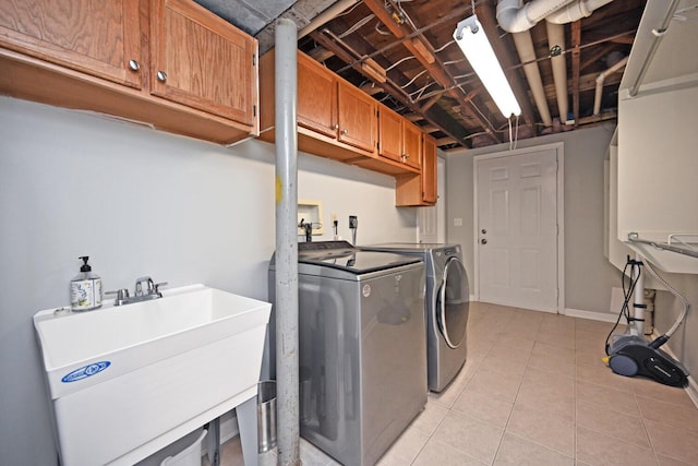 42 Daisy Ln, Fort Thomas, KY 41075 - laundry area with cabinet space, washing machine and dryer, and light tile patterned flooring