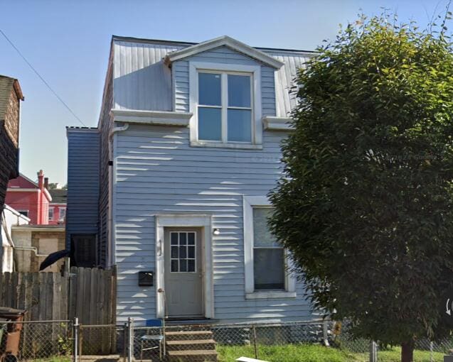 406 W 10th St, Newport, KY 41071 - view of front of house with a fenced front yard, entry steps, a metal roof, and a gate