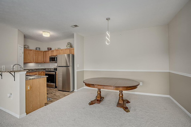 150 Saddlebrook Ln Unit 535, Florence, KY 41042 - kitchen featuring stainless steel appliances, light colored carpet, pendant lighting, and a peninsula