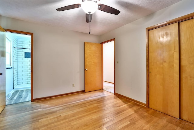 1710 Hilltop Dr, Carrollton, KY 41008 - unfurnished bedroom with a closet, light wood finished floors, ensuite bath, a textured ceiling, and a ceiling fan