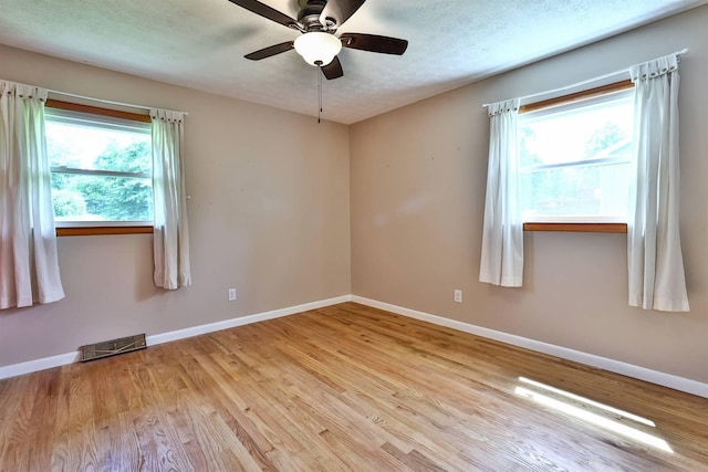 1710 Hilltop Dr, Carrollton, KY 41008 - empty room with light wood-style floors, ceiling fan, and a textured ceiling