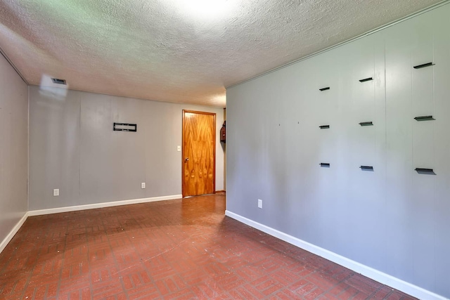 1710 Hilltop Dr, Carrollton, KY 41008 - spare room with a textured ceiling and brick patterned flooring