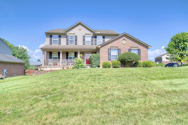 1025 Wakefield Ct, Hebron, KY 41048 - view of front of house with covered porch, brick siding, and a front yard