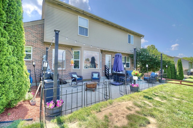 1025 Wakefield Ct, Hebron, KY 41048 - back of house with a patio area, brick siding, and an outdoor fire pit