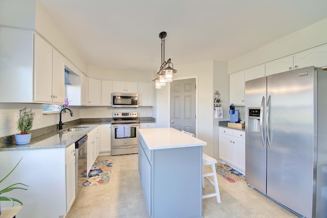 1025 Wakefield Ct, Hebron, KY 41048 - kitchen with appliances with stainless steel finishes, a kitchen island, and white cabinets
