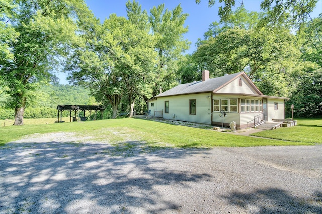 604 Rifle Range Rd, Alexandria, KY 41001 - view of home's exterior featuring a chimney, a lawn, view of wooded area, and a pergola