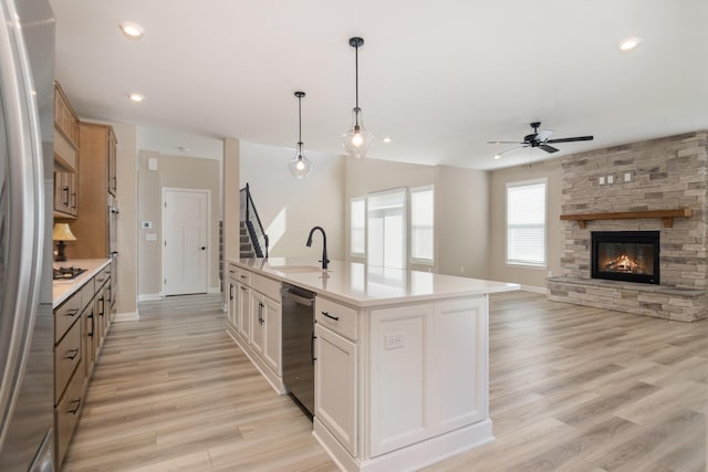 3020 Toulouse Dr, Union, KY 41091 - kitchen featuring a ceiling fan, stainless steel appliances, light countertops, light wood-type flooring, and hanging light fixtures