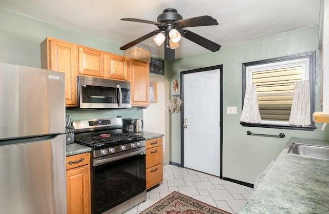 305 Helen St, Ludlow, KY 41016 - kitchen with appliances with stainless steel finishes, a ceiling fan, light tile patterned floors, and arched walkways