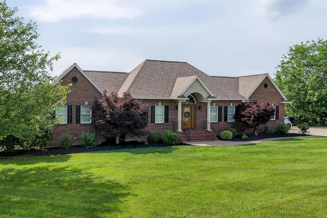 103 Mohawk Trl, Dry Ridge, KY 41035 - view of front facade with a front yard, roof with shingles, and brick siding