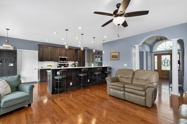 103 Mohawk Trl, Dry Ridge, KY 41035 - living room with ornate columns, wood finished floors, a ceiling fan, recessed lighting, and arched walkways