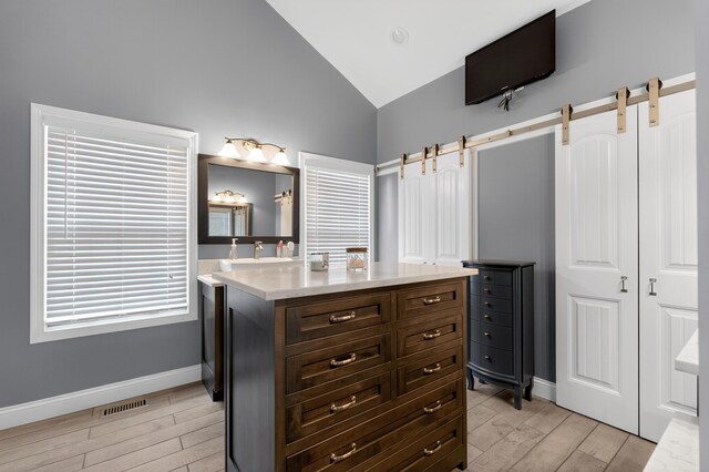 103 Mohawk Trl, Dry Ridge, KY 41035 - bathroom with wood finished floors, vanity, and high vaulted ceiling