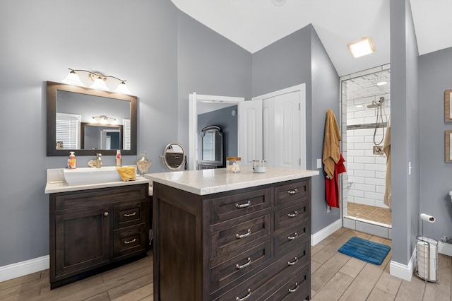 103 Mohawk Trl, Dry Ridge, KY 41035 - full bathroom featuring wood finished floors, vanity, tiled shower, and high vaulted ceiling