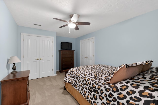 103 Mohawk Trl, Dry Ridge, KY 41035 - bedroom with light colored carpet, a ceiling fan, and two closets