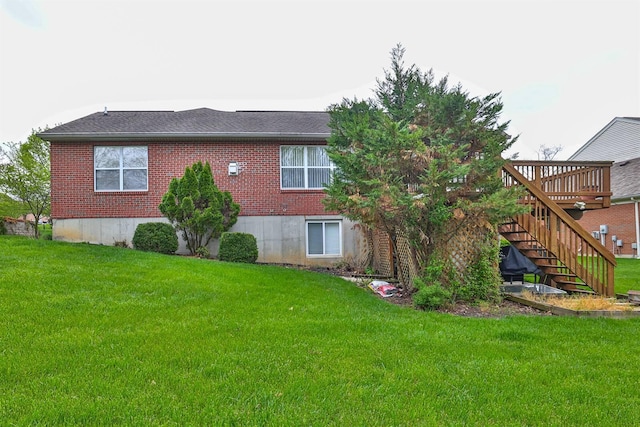 6315 Baymiller Ln, Burlington, KY 41005 - rear view of house with a deck, a lawn, stairway, and brick siding