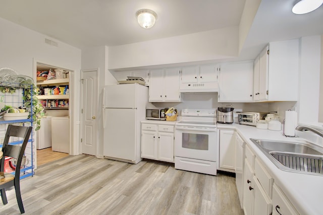 7305 Centrecrest Ln Unit G, Florence, KY 41042 - kitchen with white appliances, premium range hood, washer and dryer, light wood-type flooring, and white cabinets