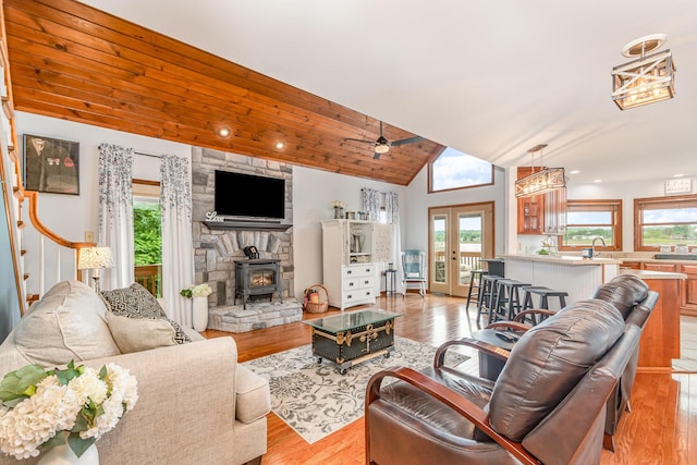 9500 Lower River Rd, Burlington, KY 41005 - living room featuring lofted ceiling, a wood stove, light wood-style floors, ceiling fan, and french doors